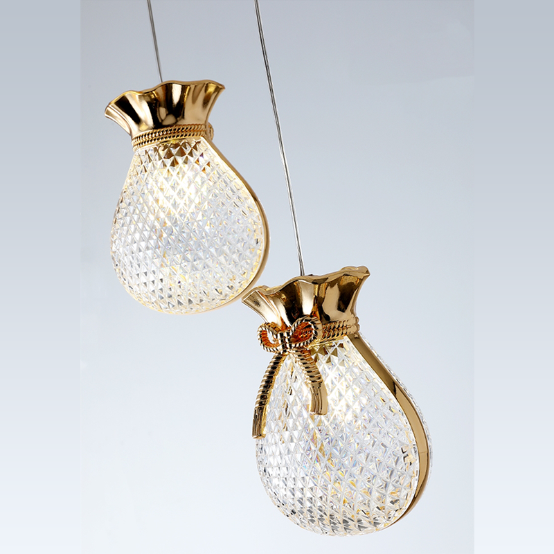 Double pendant kitchen light highlighting gold accent and clear glass 