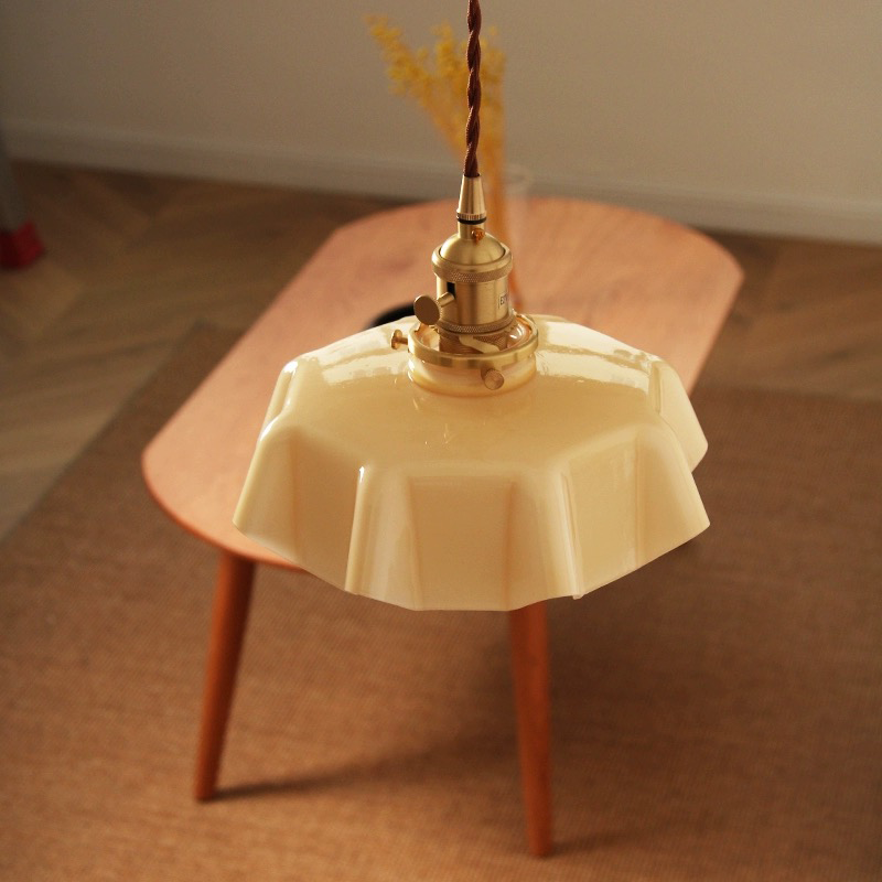 a kitchen pendant light hung over a table