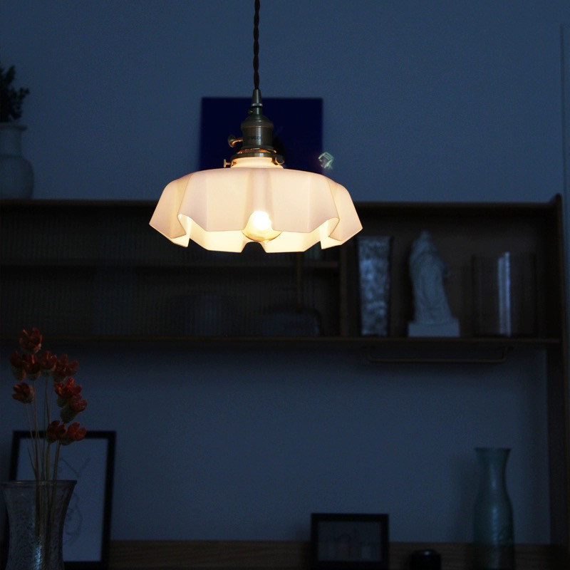 a kitchen pendant light illuminating a dimly lit room