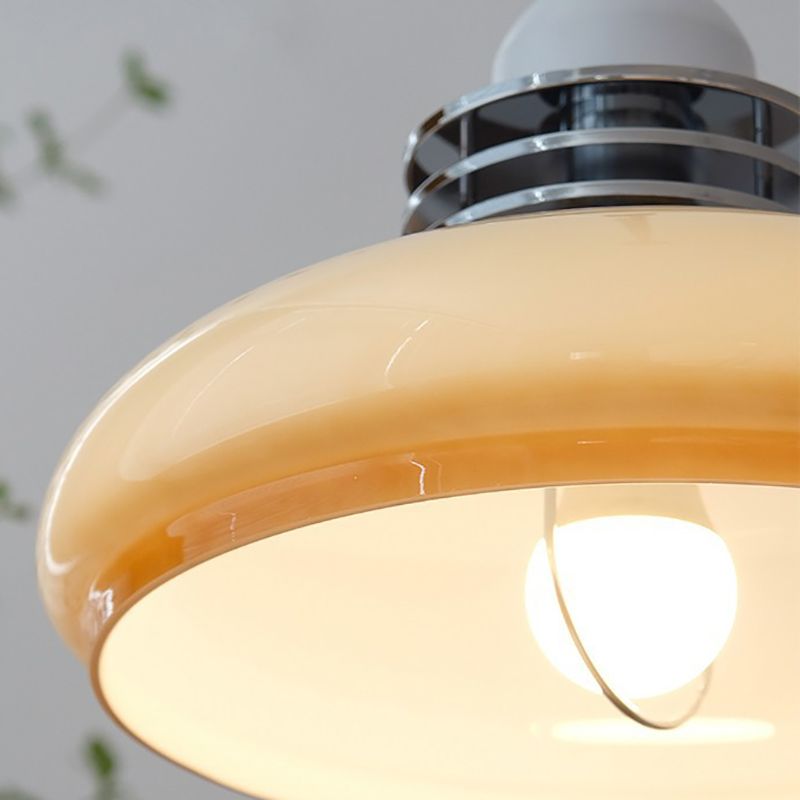 Sectioned image of kitchen island pendant light dome and light bulb 