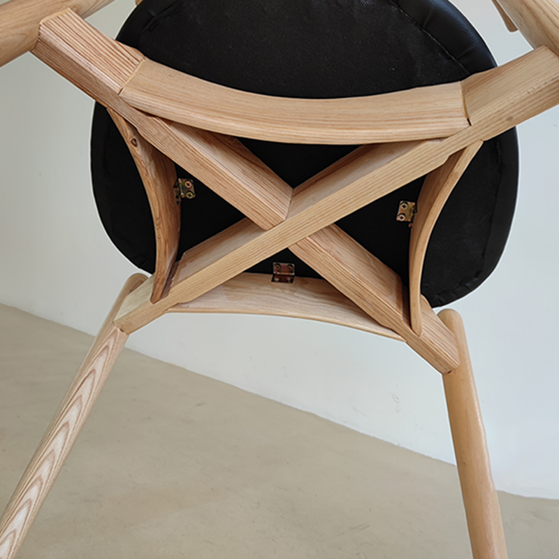 Wood dining table chair showcasing unique rail construction underneath