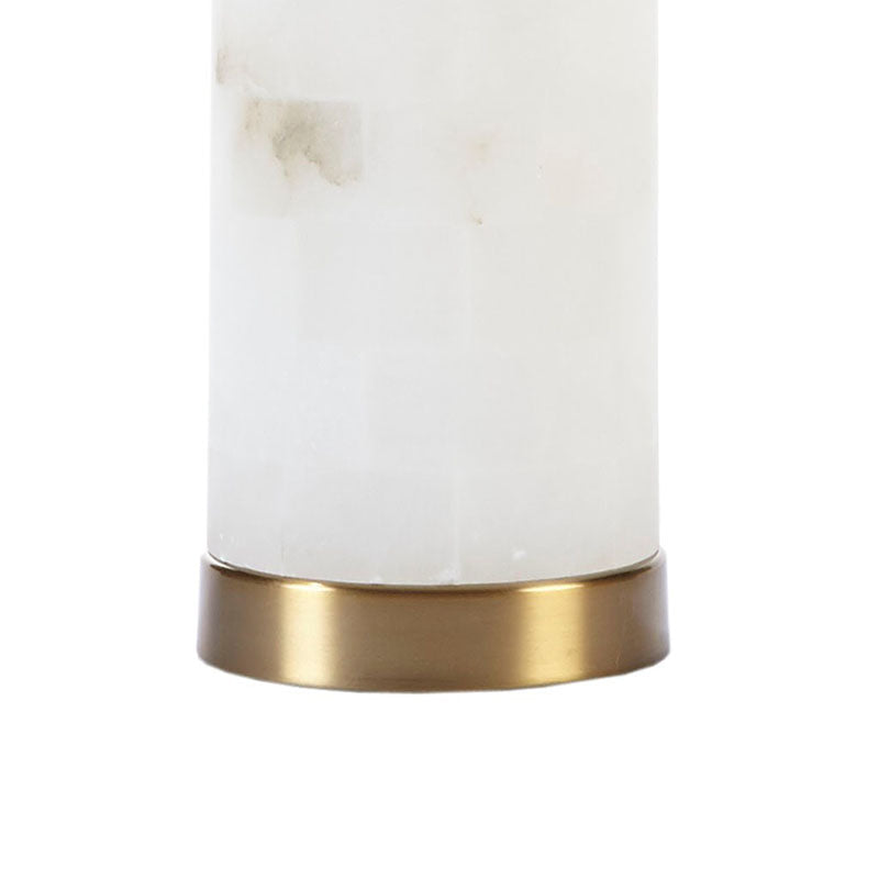 the gold base of an alabaster ceramic table lamp