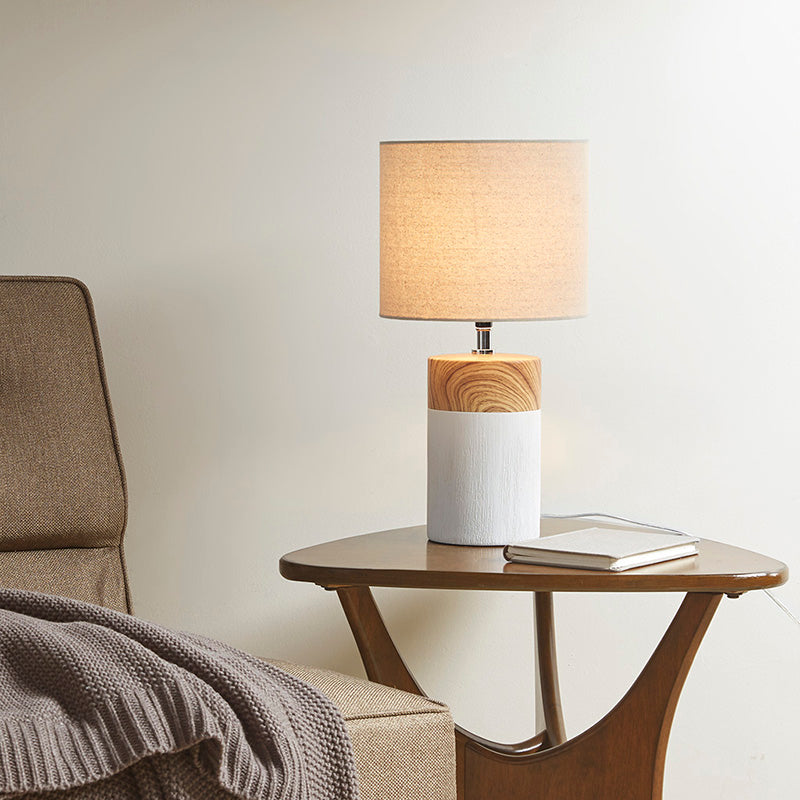 an illuminated ceramic table lamp with two-toned cylinder base