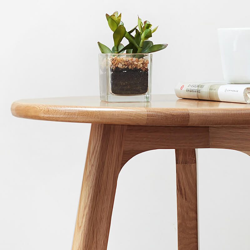 the smooth edge of a round wooden end table