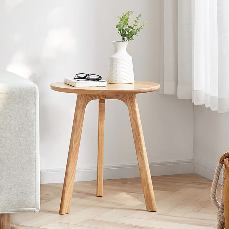 a round wood end table in natural finish, looking simle and stylish