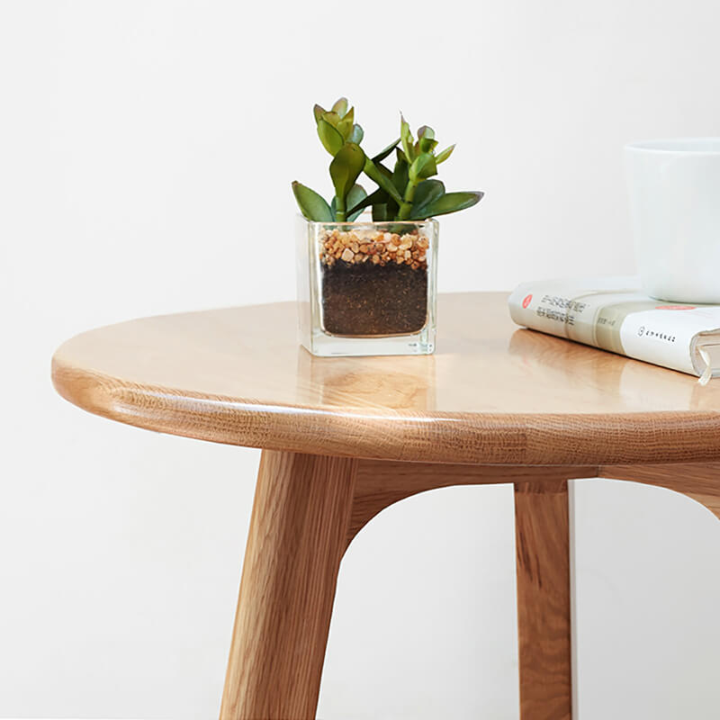 the smooth edge of a wooden end table