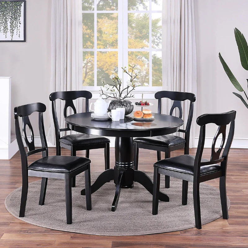 A round wooden dining table and chairs set in a chic dining area