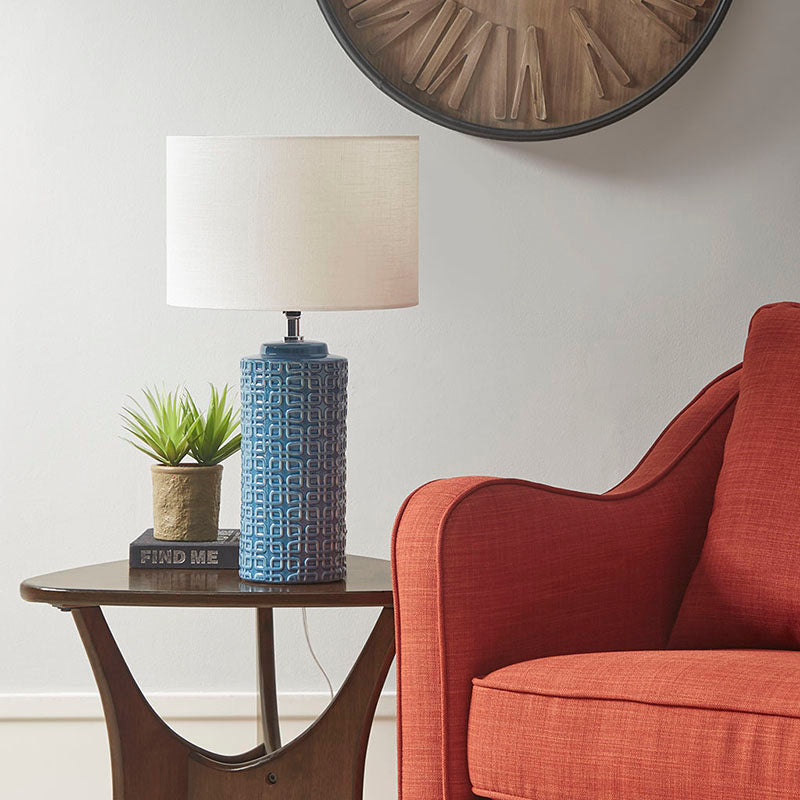 Ceramic table lamp on a side table switched off in a modern living room