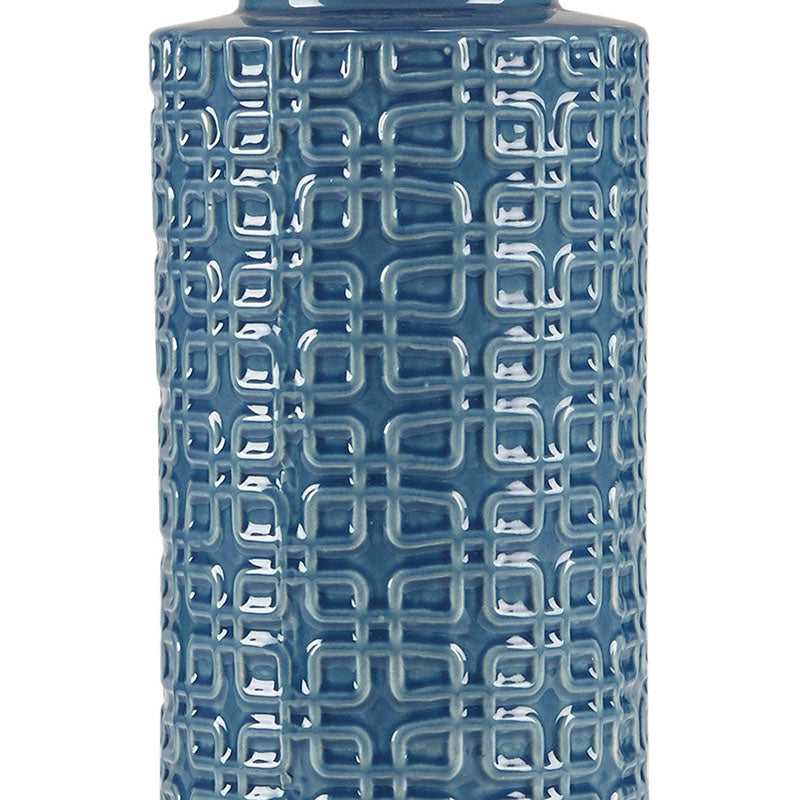 Close up view of ceramic table lamp highlighting geometric patterns on blue ceramic base