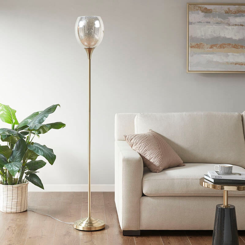 a brass midcentury modern floor lamp placed elegantly in a living area