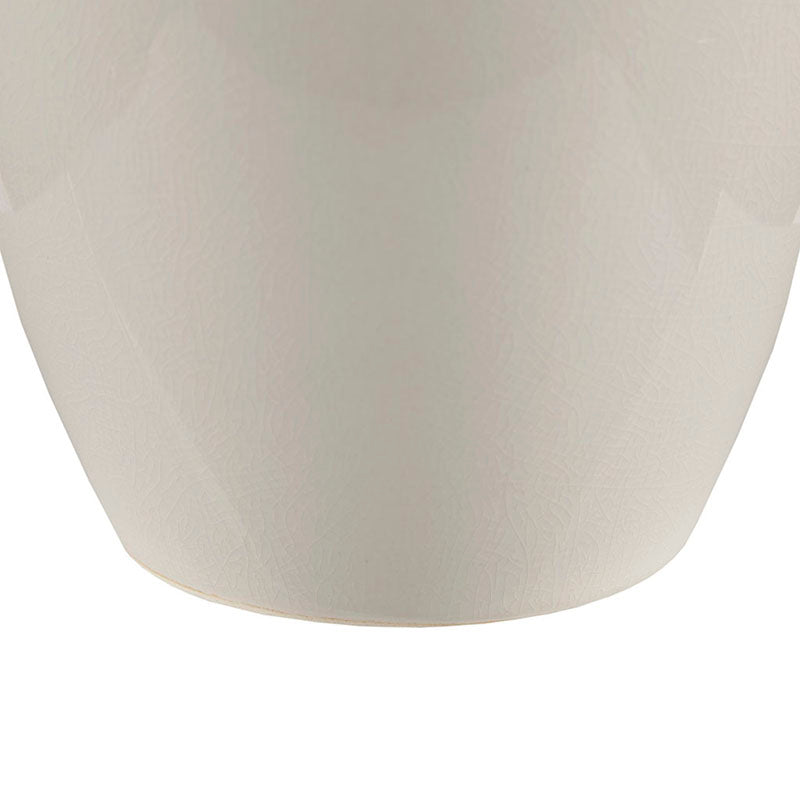 the cream base of a ceramic table lamp