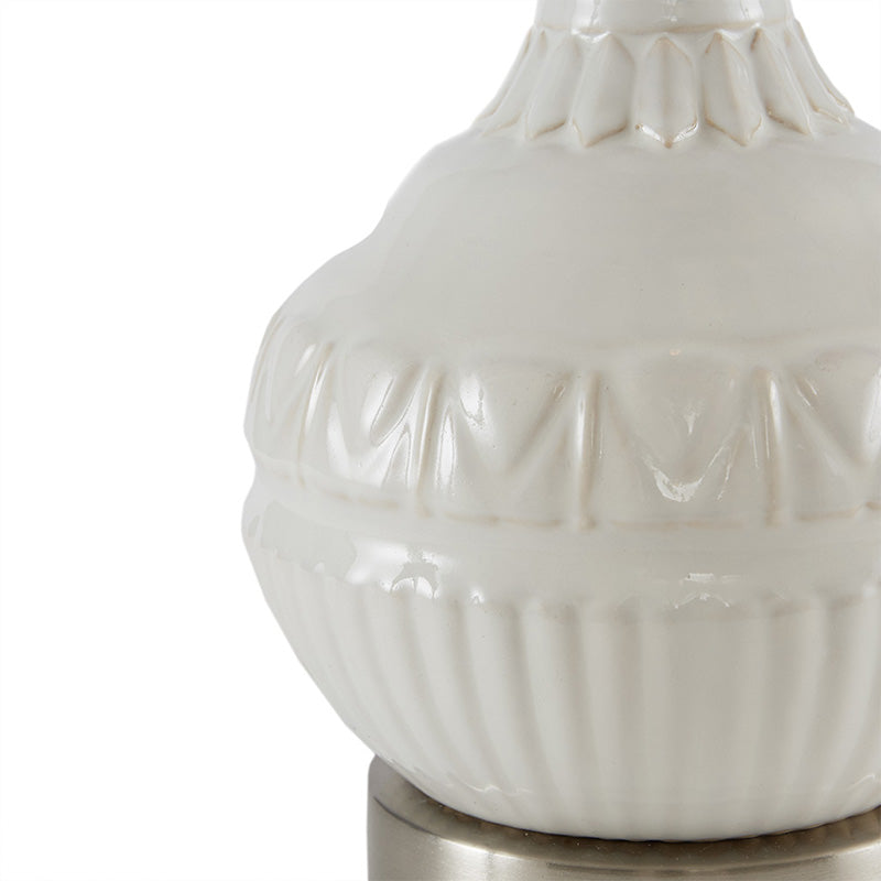 white ceramic table lamp highlighting its patterned ceramic base