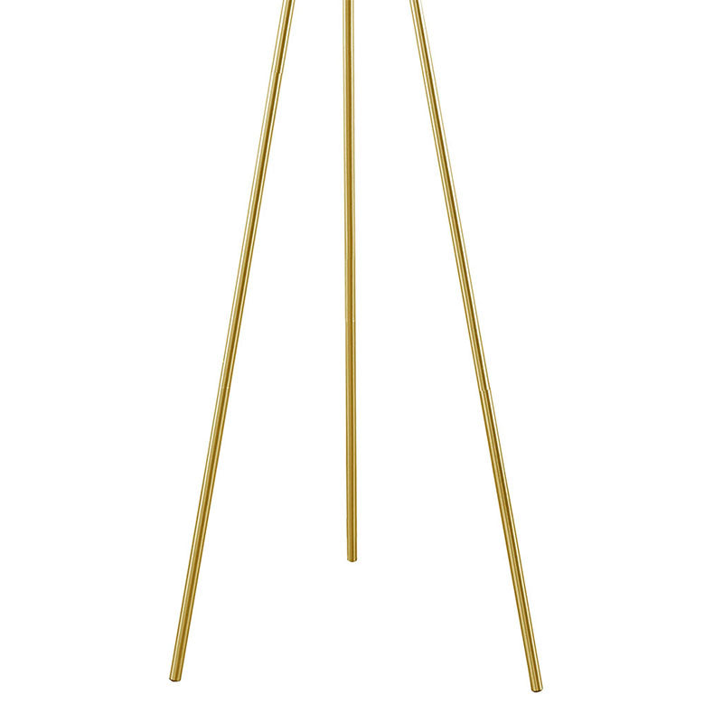 the metal tripod base of a modern floor lamp