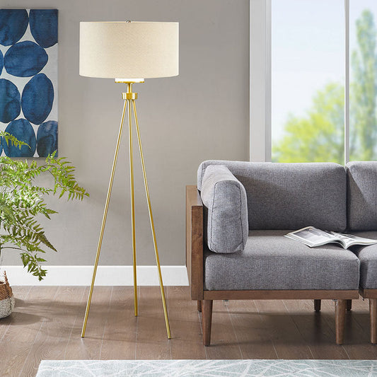 a modern gold floor lamp with glass shade and metal tripod base