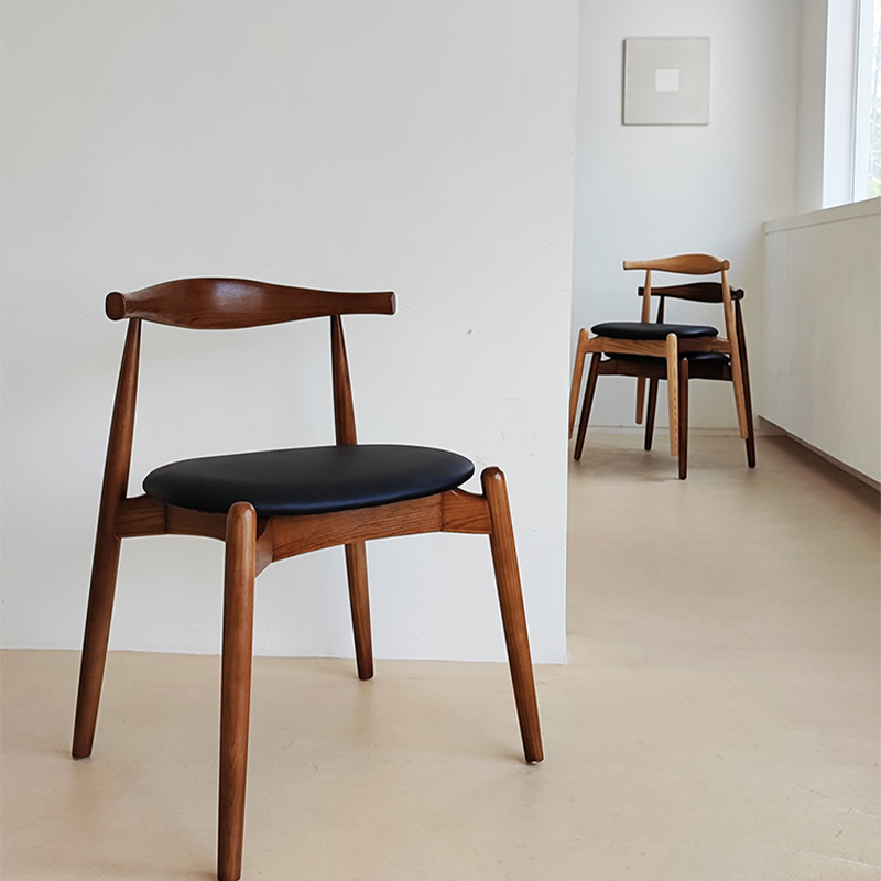 Wood dining chair with leather seat in walnut finish