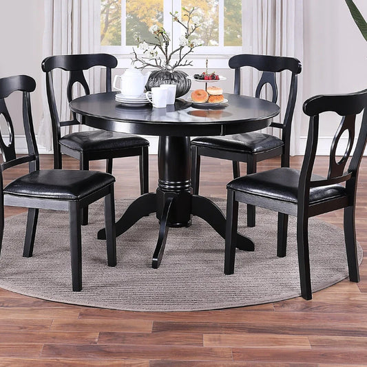 A round wooden dining table and 4 matching dining chairs