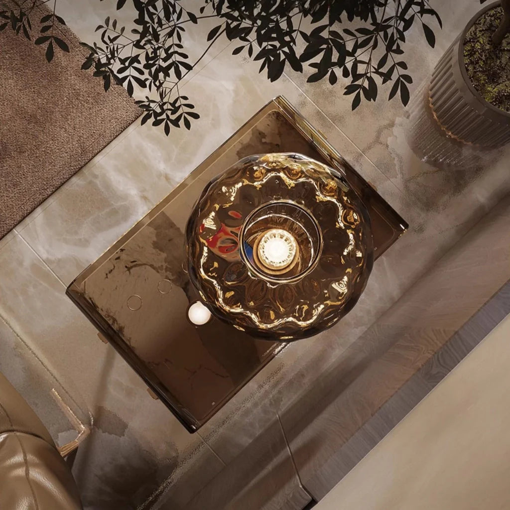 an upclose-view of a unique nightstand with acrylic frame, pine wood drawer, and gold metal legs