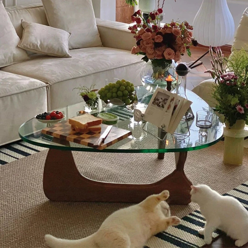 Glass wood coffee table with brown wooden base in a modern living room setting