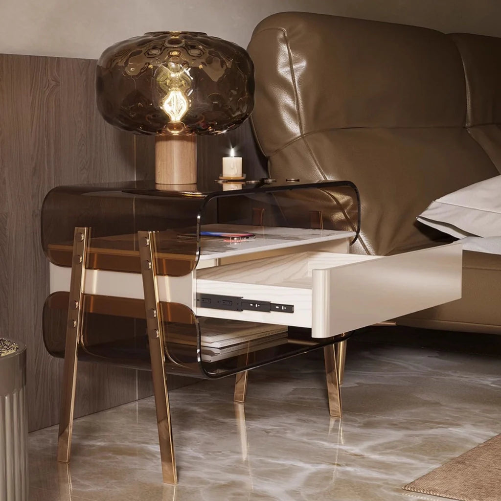 a chic modern nightstand with glossy pine wood drawers, and open storage shelves, displaying a table lamp, and a lighted candle