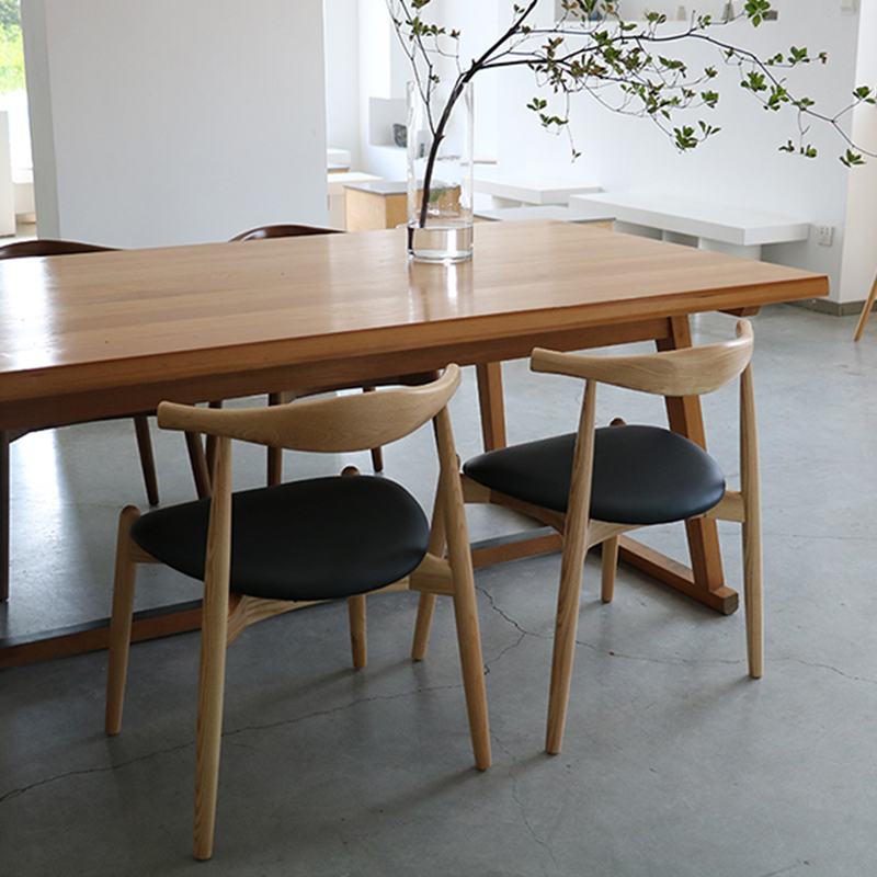 Wood and leather dining chair in a modern dining room setting