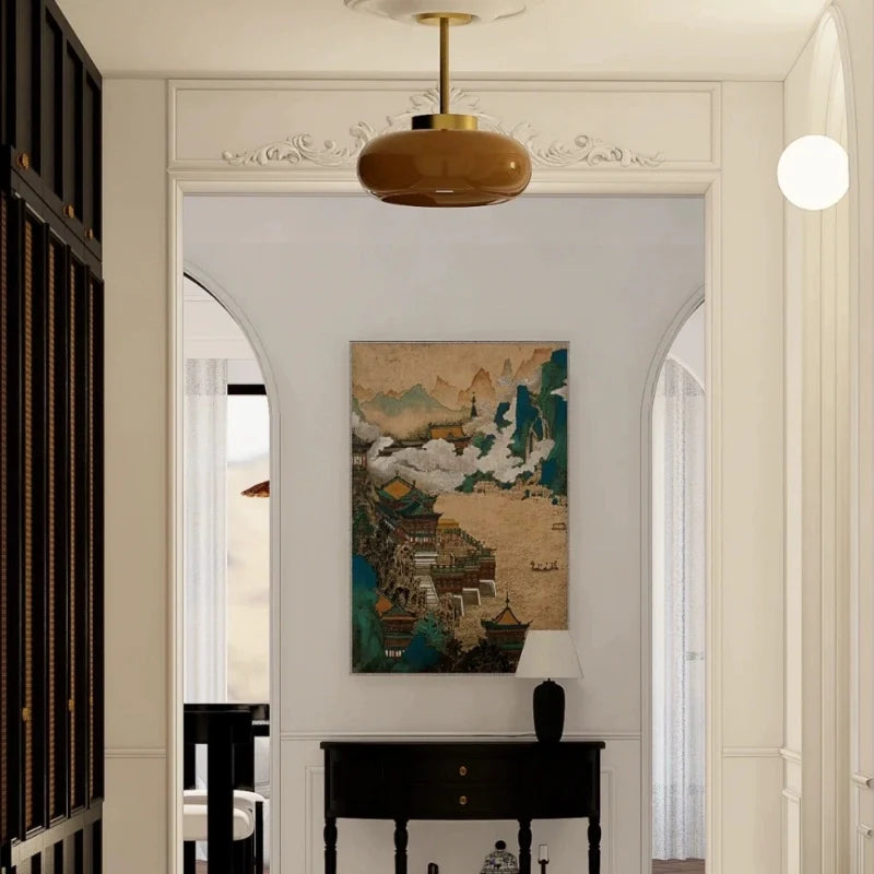 a glass pendant light in a hallway