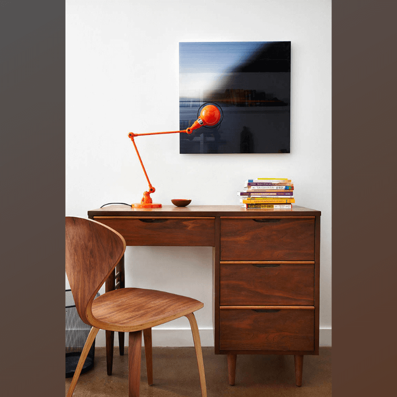 Wood dining chair in walnut finish by a study desk