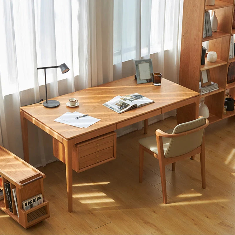 Cherry wood office desk with drawers in natural wood finish in an office setting