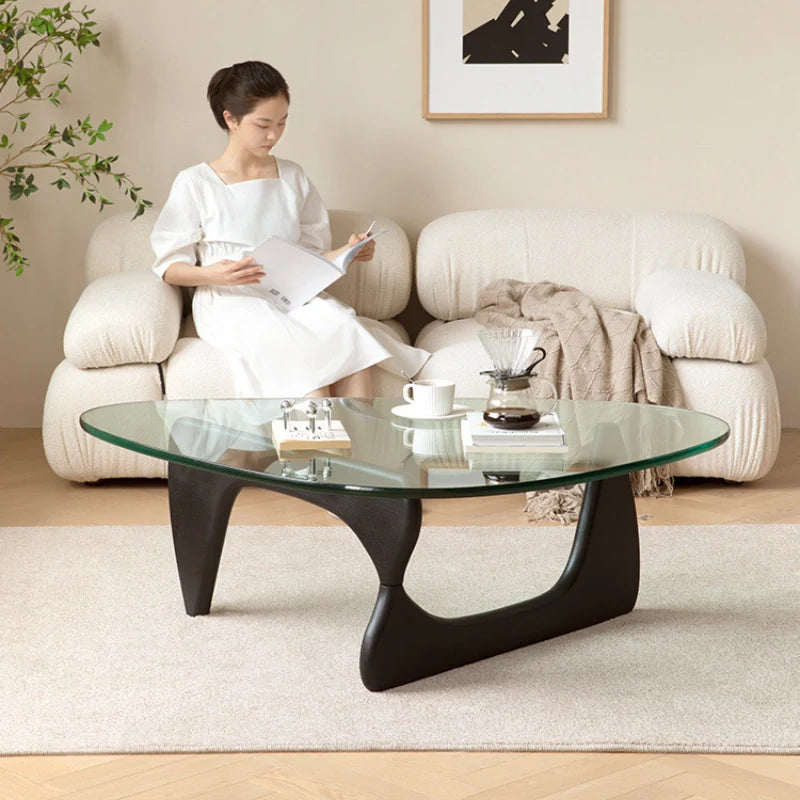 Wood and glass coffee table with black wooden base adding contrast to a bright decor theme