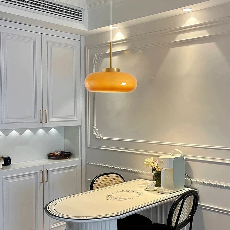 a vintage semi flush ceiling light with yellowish-brown bowl shade, hanging above a kitchen island