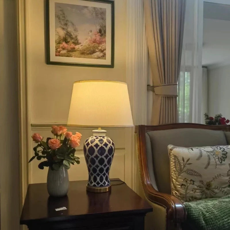 an illuminated vintage ceramic table lamp placed on a nightstand