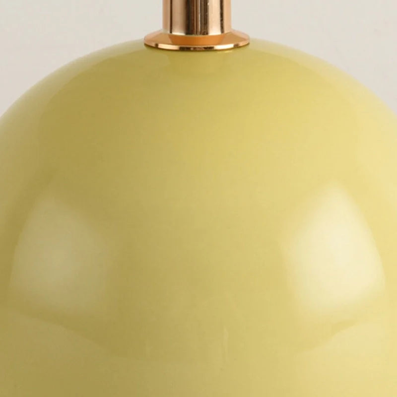 Up close view of ceramic table lamp highlighting round yellow base 