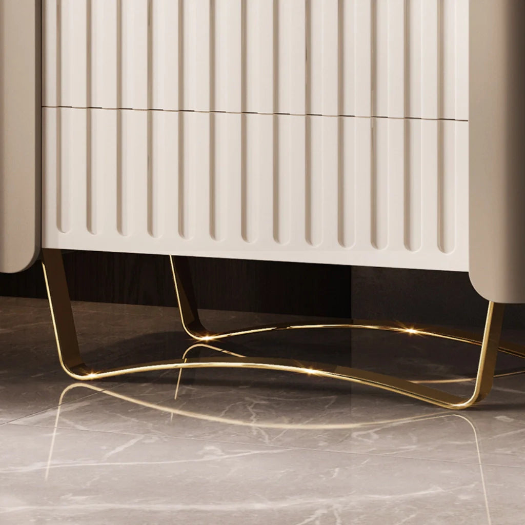 the gold metal base of a modern wooden nightstand with drawers