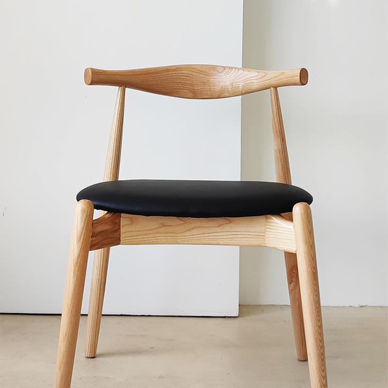 Wood dining chair with leather seat in natural wood finish