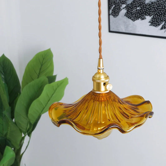 Top view of the amber glass pendant light showing, amber glass floral lamp shade and brass lamp holder