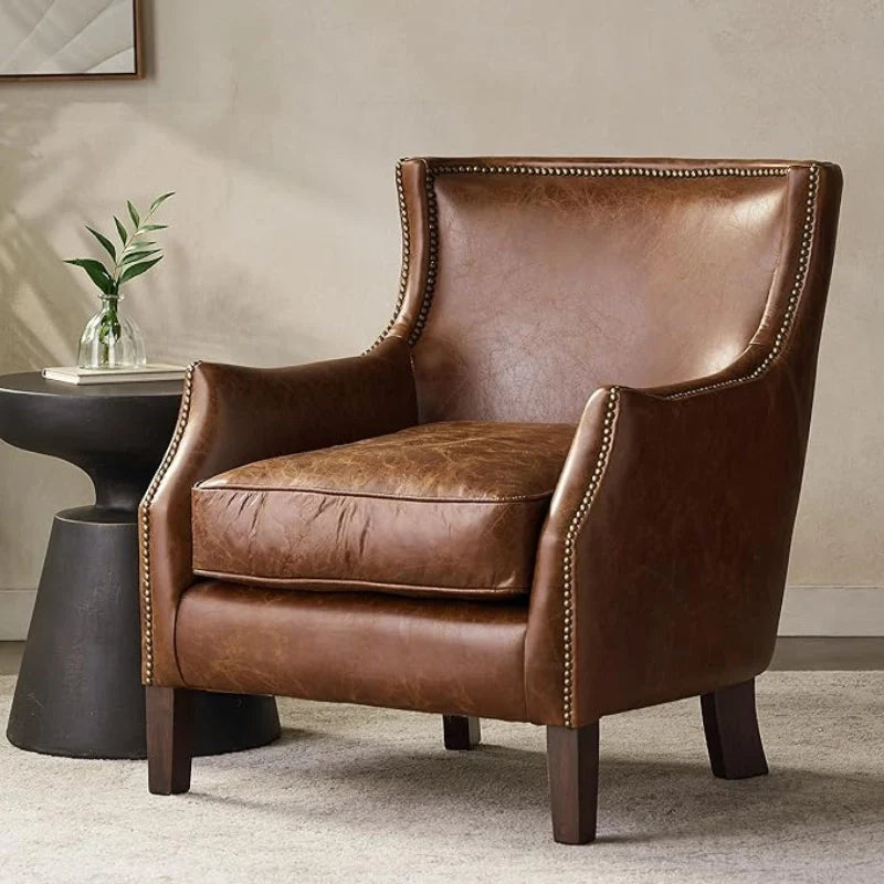 Brown leather accent chair with black side table in a modern living space