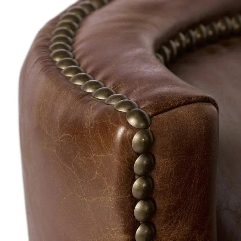 Brown leather accent chair high lighting rivet design around its edges