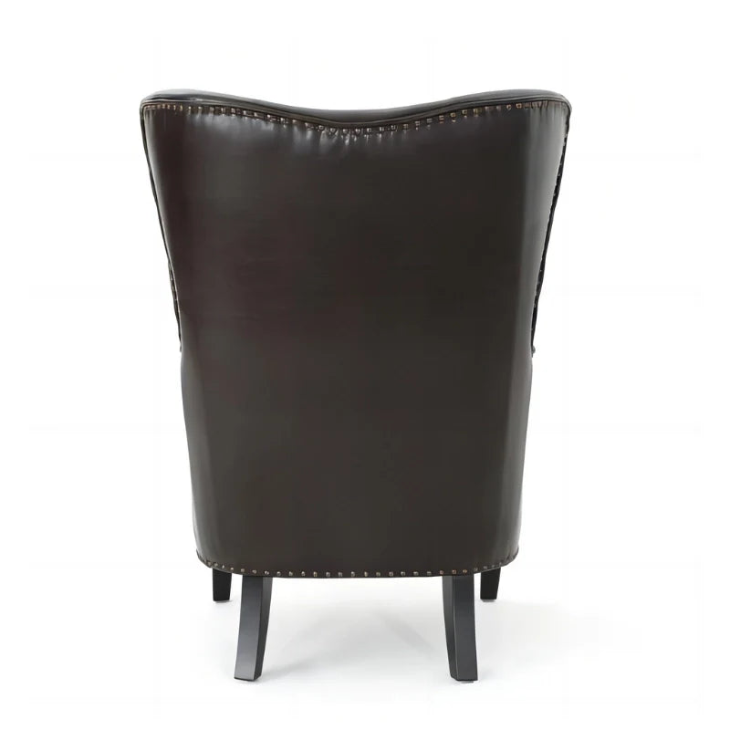 Back view of dark brown leather accent chair with tuft wing back and sturdy legs