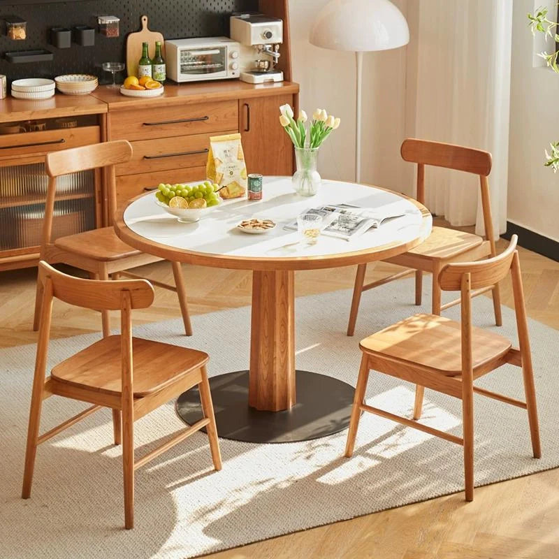 Wood Dining Chairs Placed Around a Round Dining Table 