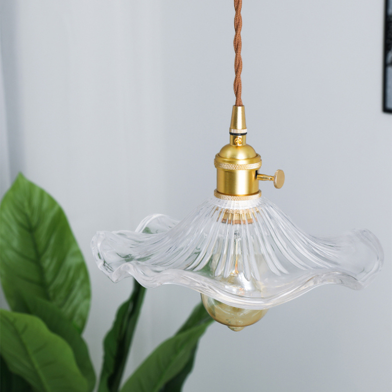 Clear Glass Pendant light showing floral lamp shade and brass lamp holder