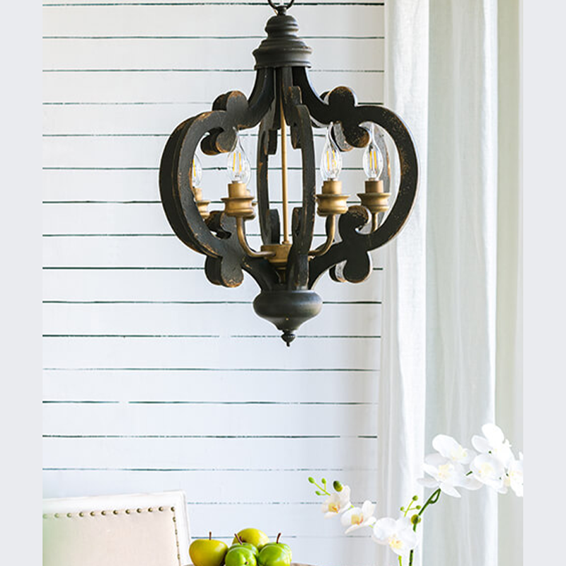 Black kitchen island pendant light hanging in a brightly lit indoor space