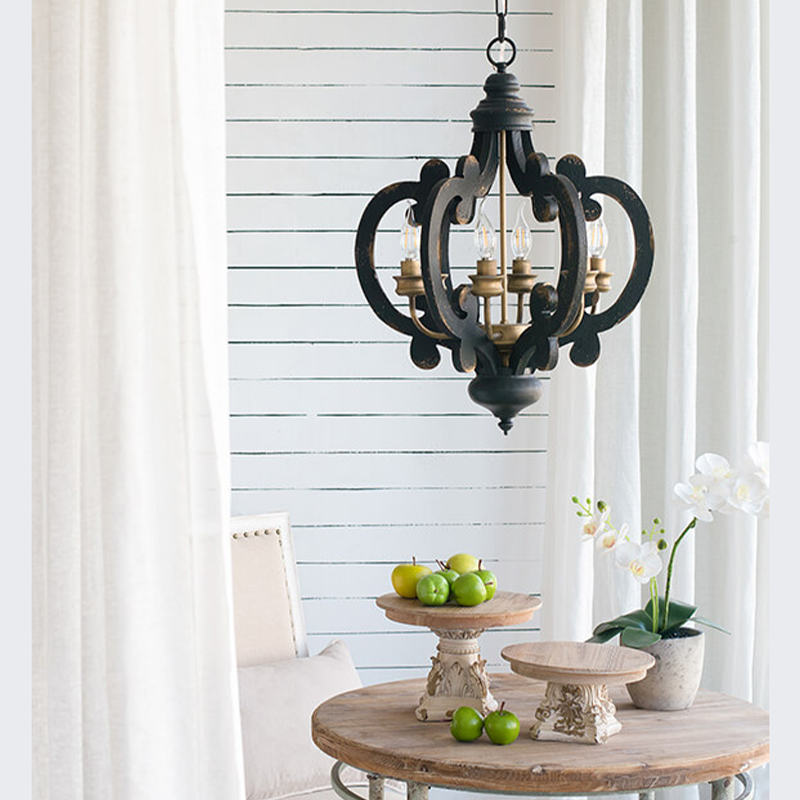 Black kitchen island pendant light hanging in a brightly lit indoor space