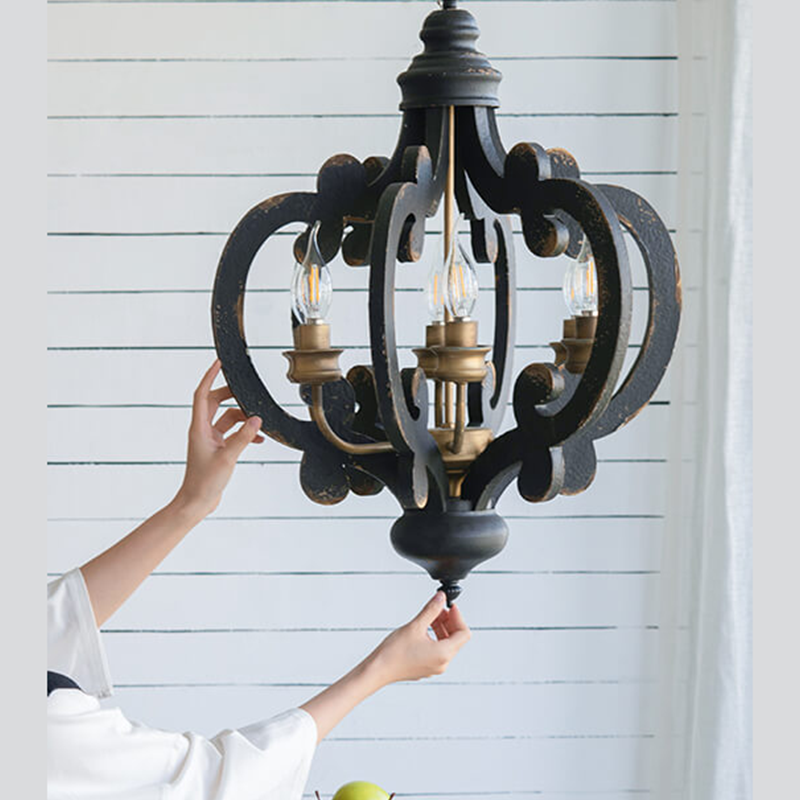 Black kitchen island pendant light hanging in a brightly lit indoor space