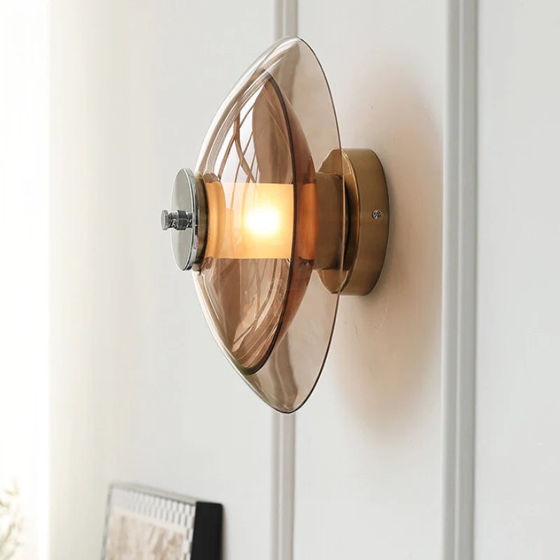 a plug in wall light with amber glass shade mounted on a wall