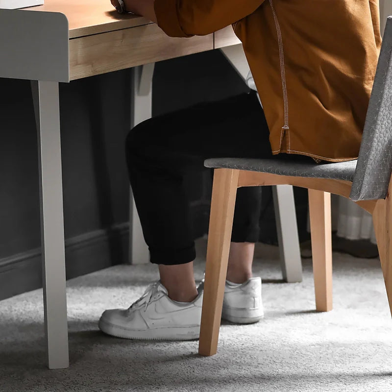 the sturdy legs of a wood desk