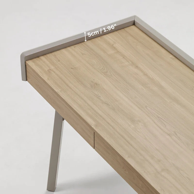 the smooth tabletop of a wooden desk