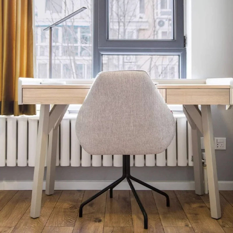 a wooden computer desk paired with a matching chair