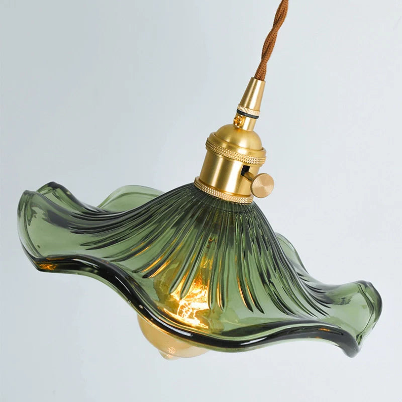 Top view of ceiling mounted green glass pendant light showing, green glass floral lamp shade and brass lamp holder in gold finish