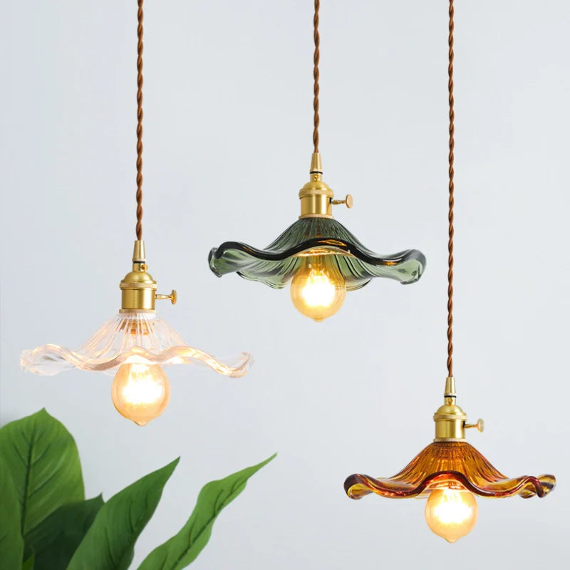 Image of illuminated Clear glass, amber and green glass pendant light