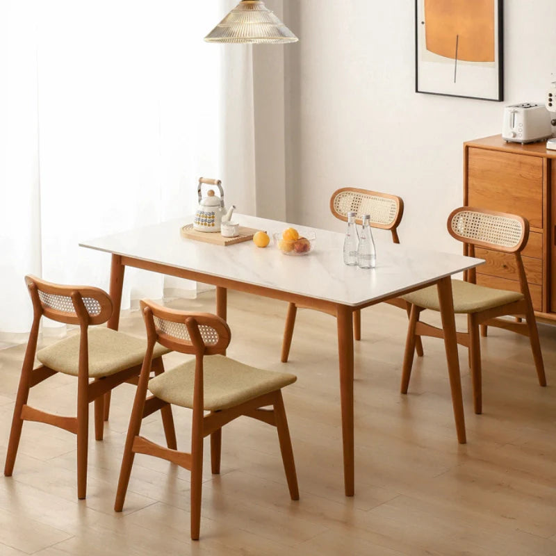 Rattan Dining Chairs arranged around a Wood Dining Table