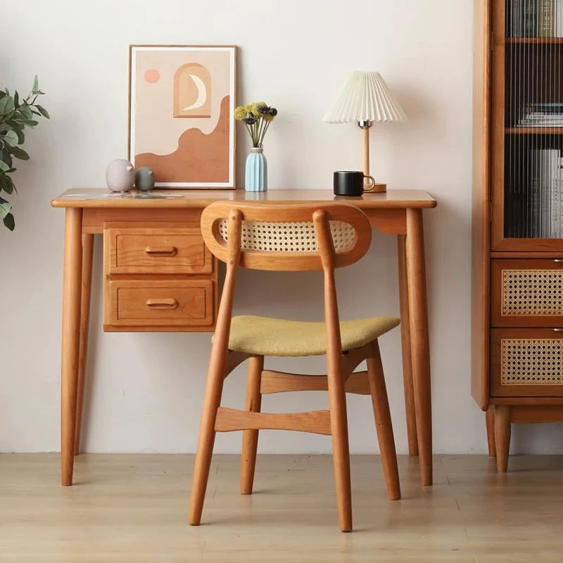 A Rattan Dining Chair with Cushion placed before a Wooden Desk